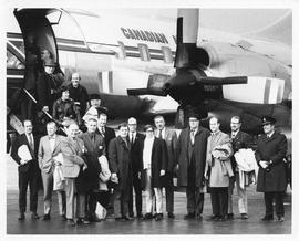 Photograph of Henry Hicks and a group of unidentified people boarding a CAF aircraft