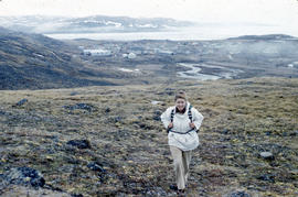 Photograph of Barbara Hinds walking up a hill near Frobisher Bay, Northwest Territories