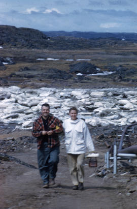 Photograph of Barbara Hinds walking with an unidentified man in Frobisher Bay, Northwest Territories