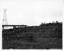 Photograph of train tracks and the MacKay Bridge on-ramp under construction
