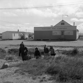 Photograph of people walking away from a Hudson's Bay Company store in Fort Chimo, Quebec