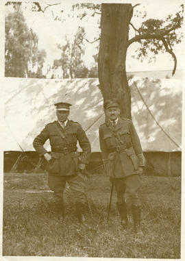 Two officers standing under a tree