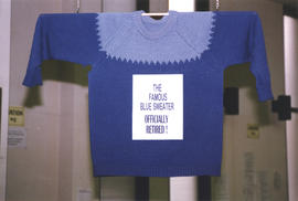 Photographs of Bill Owen's famous blue sweater on display for his retirement from the Kellogg Lib...