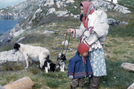 Photograph of a woman, a child, and dogs in the eastern Arctic