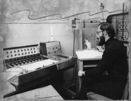 Photograph of Dr. Goddard and rat experiment