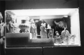 Photograph of person looking in an exhibit case