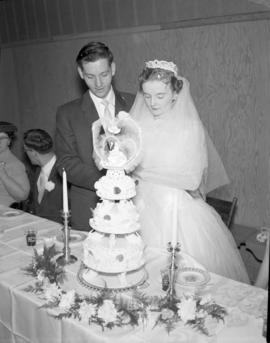 Photograph of Mr. & Mrs. Wright cutting the wedding cake