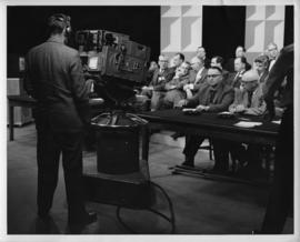 Photograph of a group of unidentified people in front of a Canadian Broadcasting Corporation camera