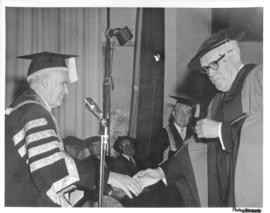 Photograph of Chancellor C.D. Howe shaking hands with an unidentified person