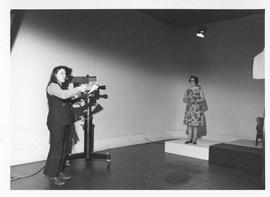 Photograph of an unidentified person filming a television segment