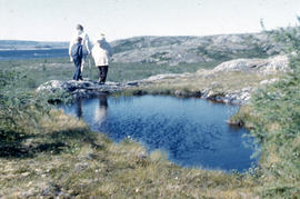 Photograph of three people walking by a pond near Fort Chimo, Quebec