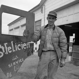 Photograph of Giles Dumas standing next to the open door of a Jeep in northern Quebec