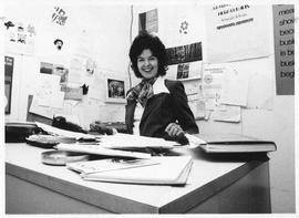 Photograph of Kate Carmichel sitting at a desk