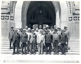 Photograph of 20 unidentified people on steps of large building related to health meetings