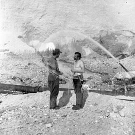 Double exposure photograph of two men at a quarry