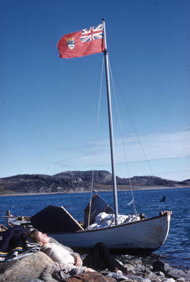 Photograph of a small boat that is flying a Canadian flag