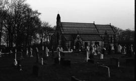 Photograph of a graveyard and church