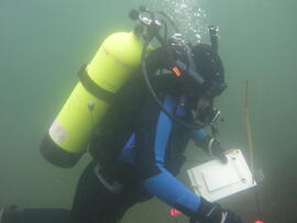 Photograph of diver with clipboard underwater