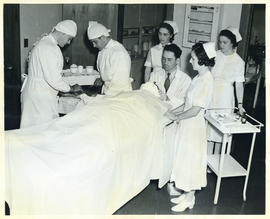 Photograph of doctors and nurses preparing to operate