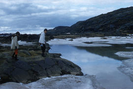 Photograph of Barbara Hinds and another woman walking by the water in Frobisher Bay, Northwest Te...