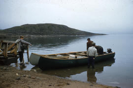 Photograph of four people with two canoes in Frobisher Bay