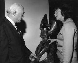 Photograph of Henry Hicks and an unidentified woman with a statue