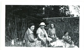 Photograph of Hilda, Ellen, Edith, and Tommy Raddall, Jr. sitting at a picnic, taken near Porters...