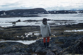 Photograph of Sue standing on rocks in Frobisher Bay, Northwest Territories
