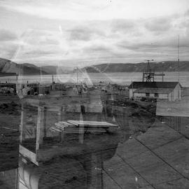 Double exposure photograph of a group of small houses in northern Quebec
