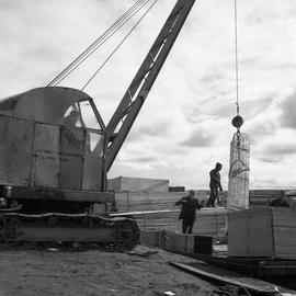 Photograph of construction material being lifted with a crane