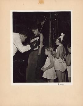 Photograph of doctor taking x-rays of children at the Outpatient and Public Health Clinic