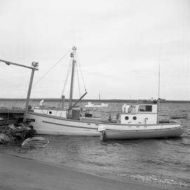 Photograph of fishing boats and canoes on the water in Northern Quebec