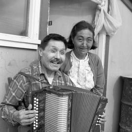 Photograph of Jimmy Koneak and his wife with an accordion in Fort Chimo, Quebec