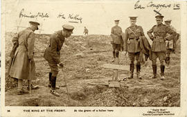 Photograph of George V at the grave of a soldier on the front lines of the Great War printed on a...