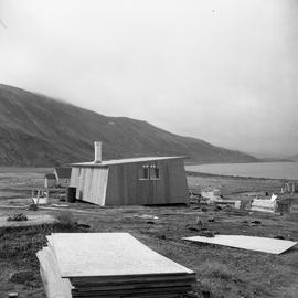 Photograph of a carpenter's house surrounded by construction materials in northern Quebec