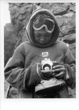 Photograph of an unidentified boy holding a camera