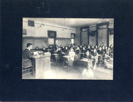Photograph of children being taught in a one-room classroom