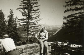 Photograph of two people sitting at a lookoff in Alberta