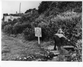 Photograph of two people at a well in Africville