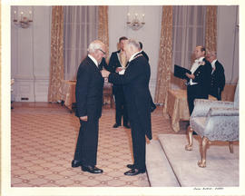 Photograph of Governor General Roland Michener presenting Thomas Head Raddall with the Medal of S...