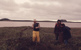 Photograph of Bill Freedman and two other researchers creating a control oil spill near Tuktoyakt...
