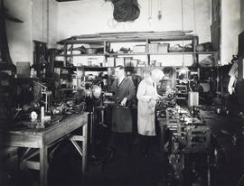 Photograph of two men working in a shop in the Science Building