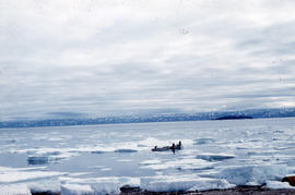 Photograph of two small boats and ice floes in Frobisher Bay