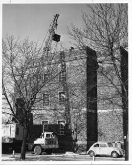 Photograph of an IBM 1620 computer being hoisted into the Dunn Building