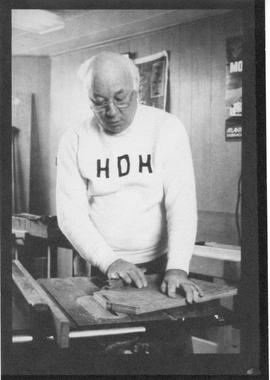 Photograph of Henry Hicks sawing wood