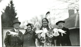 Photograph of Grey Owl with Jack Miner and two unnamed women holding birds at Miner's bird sanctu...