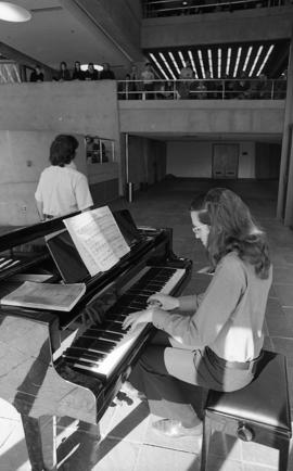 Photograph of an unidentified person playing the piano in the Dalhousie Arts Centre