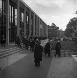 Photograph of a convocation procession in front of the Tupper Building