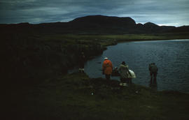 Photograph of a group of people walking by a lake near Cape Dorset, Northwest Territories