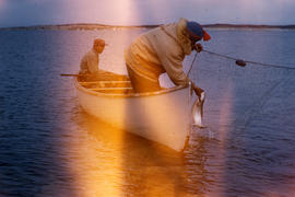 Photograph of two men fishing in a canoe in Fort Chimo, Quebec